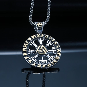Macro view of Viking Vegvisir compass pendant with gold Valknut and runes detail