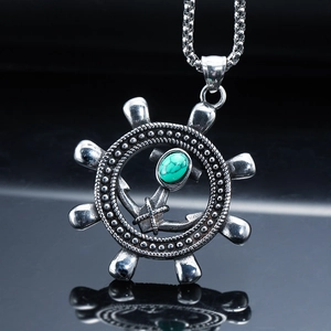 Detailed close-up of retro punk ship rudder pendant with turquoise stone inlay