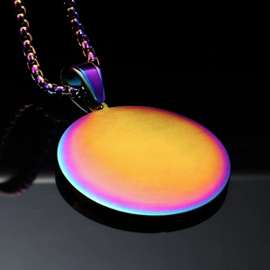 Detail of round compass pendant with rainbow gradient finish and box chain necklace