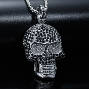 Macro view of hip hop skull pendant with black and white rhinestones and steel chain