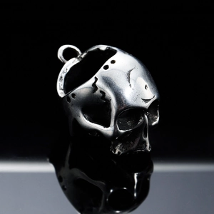 Gothic silver skull pendant in vintage stainless steel with reflection on black base