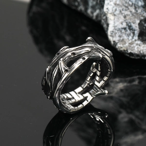 Macro shot of retro stainless steel crown ring with detailed thorn and branch texture