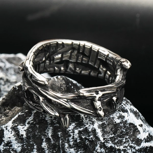 Macro detail of gothic thorn crown ring made of vintage steel on dark volcanic rock