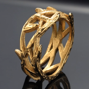 Detailed macro view of vintage thorn crown ring with textured antique gold finish