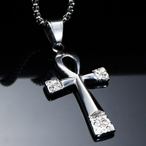 Macro shot of polished silver Ankh cross pendant with sparkling rhinestones on bead chain