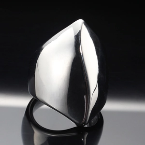 Geometric twisted stainless steel ring with polished mirror finish on reflective black background