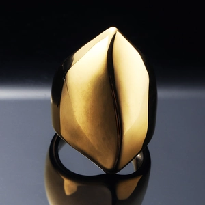 Polished gold stainless steel ring featuring a geometric abstract flame design on black background