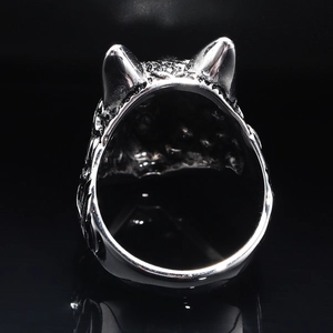 Macro view of silver Viking wolf head ring featuring intricate punk textures and details
