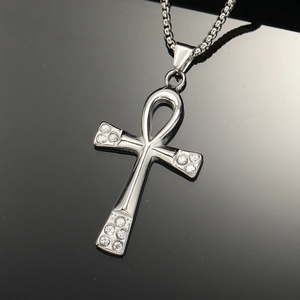 Close-up of polished silver Ankh cross pendant with sparkling rhinestones on chain