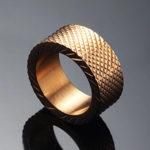 Industrial rose gold stainless steel ring with diamond knurling and diagonal grooves