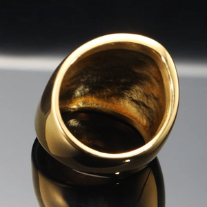 Minimalist wide golden stainless steel ring with polished finish and hammered inner texture