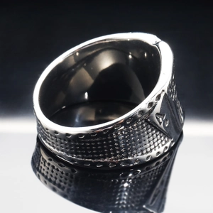 Macro detail of punk poker flush ring showing embossed texture and Ace of Spades design