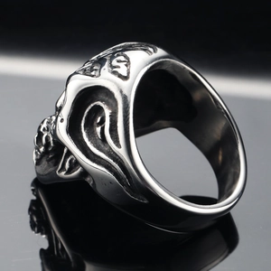 Gothic punk stainless steel skull ring with flame and rose carvings in a side view