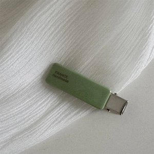 Detail of matcha green acetate hair clip with silver clip and France Handmade logo