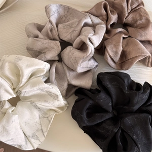 Elegant satin scrunchies set with ink marble texture in neutral tones for women