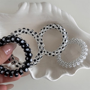 Close-up of elastic spiral telephone cord hair ties with classic polka dot pattern prints