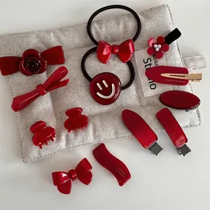 Elegant deep red acetate hair accessories set including bow clips and floral hair claws
