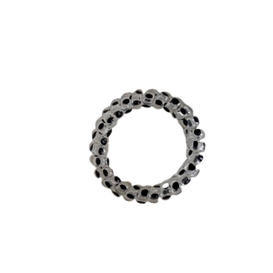 Elastic spiral hair tie with black polka dots in transparent finish on white background