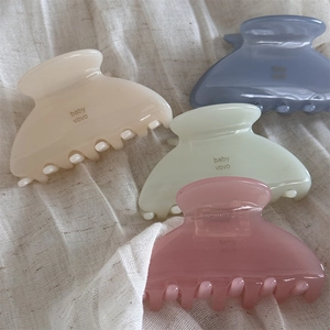 Macro shot of jelly texture hair claws in pastel colors with baby vovo print details