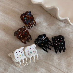 Detail view of mini bear-shaped hair clips with colorful rhinestones in three elegant colors
