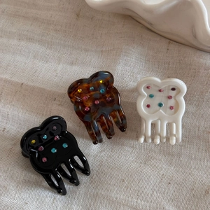 Set of three floral hair clips in black, tortoiseshell and cream with colorful rhinestones