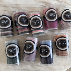 Elastic velvet hair scrunchies in transparent plastic tubes with various colors