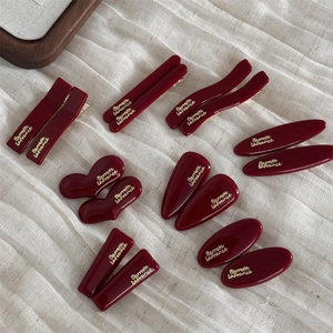 Set of 14 burgundy resin hair clips with gold lettering on elegant beige linen fabric
