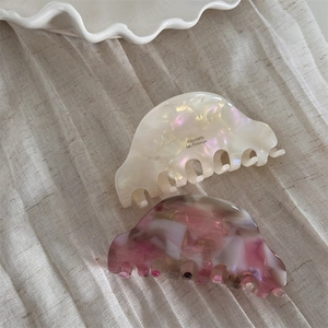 Set of two acetate hair claws in pearl white and marble pattern with gold logo detail
