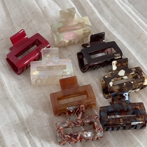 Close-up of assorted tortoiseshell acetate hair claws with gold France Handmade lettering