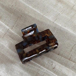 Detail of tortoiseshell acetate hair claw clip with FRANCE Handmade gold lettering