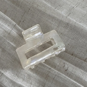 Close-up of handmade cream acetate hair claw clip showing fine craftsmanship details