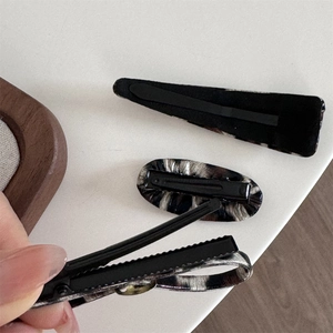 Detailed close-up of leopard print hair clips showing high-quality fabric texture and clips