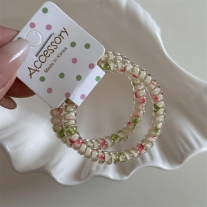 Detail of pink floral telephone wire hair ties with white polka dot packaging card