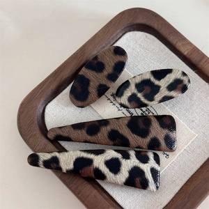 Retro leopard print faux leather hair clips set in four pieces with chic wood tray styling