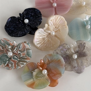 Phalaenopsis orchid hair clips set in assorted acetate textures and pearl centers