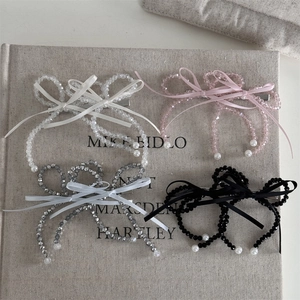 Detail view of handmade beaded bow hair clips with pearls in four elegant pastel colors