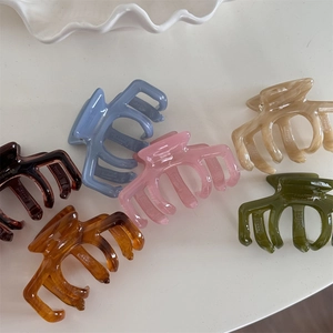 Detailed view of six handmade acetate hair claws in diverse jelly colors and patterns