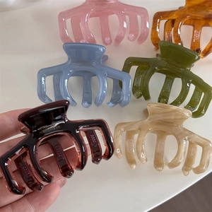 Macro detail of high-quality jelly colors acetate hair claws with gold France handmade logo
