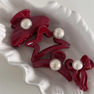 Set of four deep red hair clips with glossy resin finish and central white pearl accents