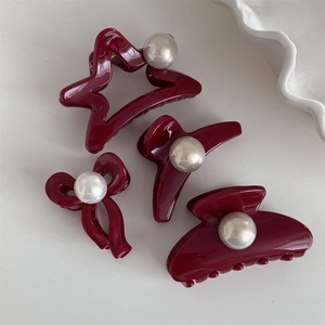 Set of four burgundy hair claws with white pearls including star and bow shapes