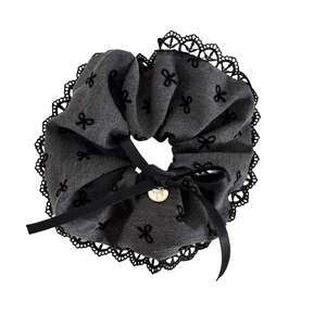 Grey denim texture scrunchie with black lace trim and golden bow pendant detail