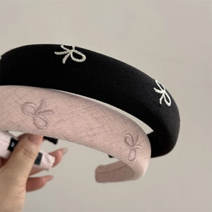 Elegant sponge padded headband with bow embroidery in black and powder pink colors