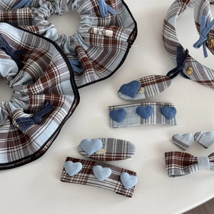 Detailed close-up of British style blue plaid hair accessories and denim heart clips