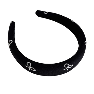 Elegant black padded headband with white embroidered bows on high crown sponge base