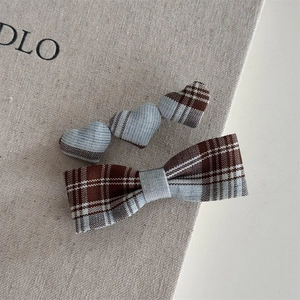Detail of British style blue plaid bow hair clip and triple heart barrette set for women