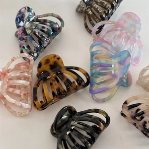 Flat lay of diverse acetate shell hair claws with marble and tortoiseshell patterns