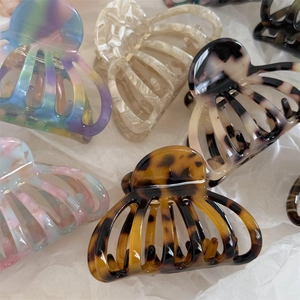 Detail showing various acetate ocean shell claw clips in marble and tortoiseshell patterns