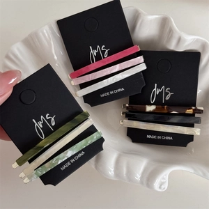Set of 3 minimalist acetate hair clips in various colors on a display card