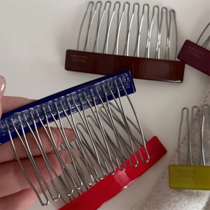 Detail of multi-color acetate hair combs with France Handmade text and metal teeth