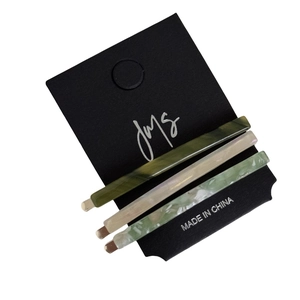 3-piece acetate hair clip set in dark green, beige, and floral green patterns